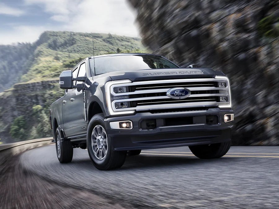 A gray truck driving on a road.