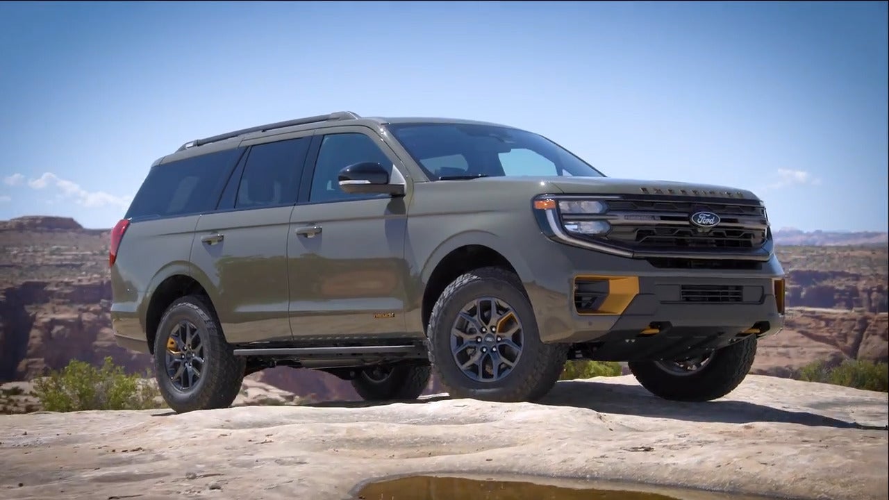 a ford expedition in dark matter metallic parked on a cliff overlooking a canyon