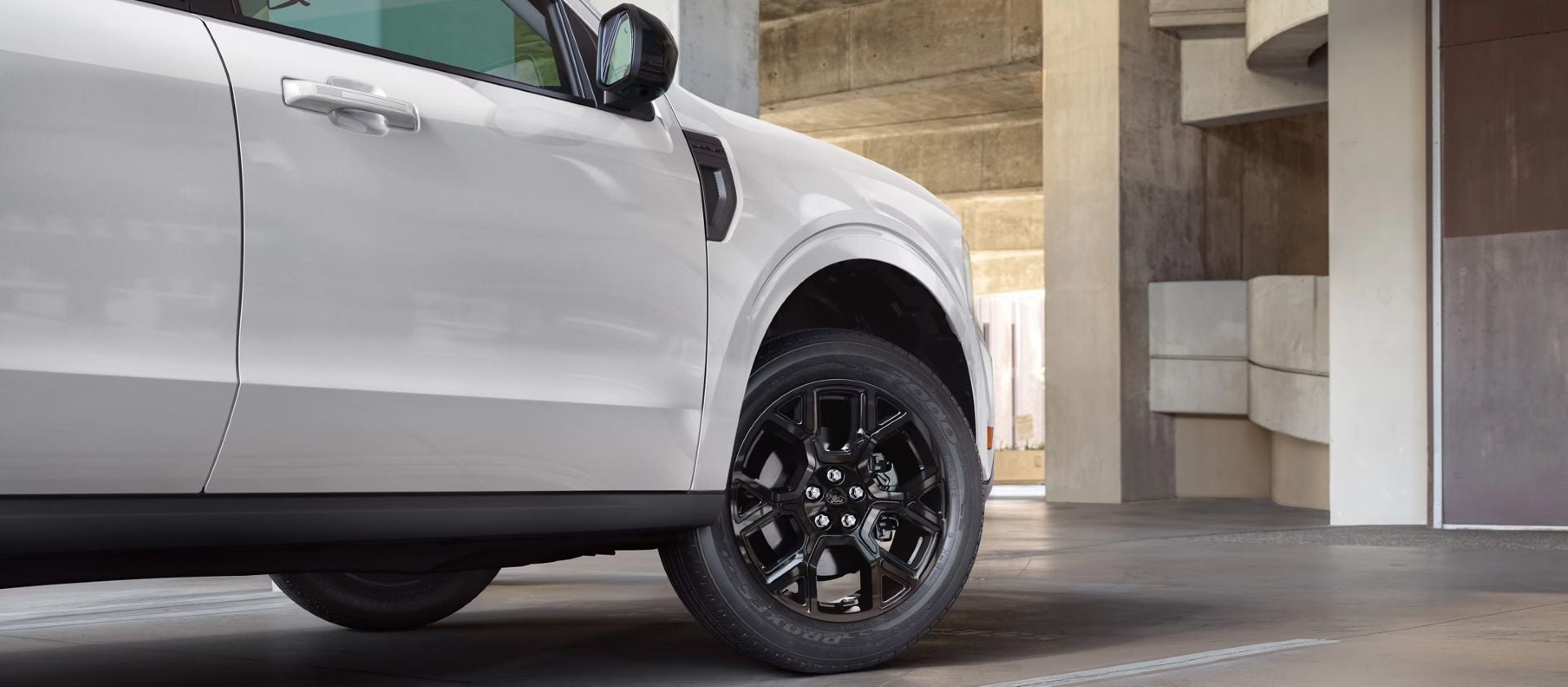 a white ford maverick showcasing the close up of the front passenger side