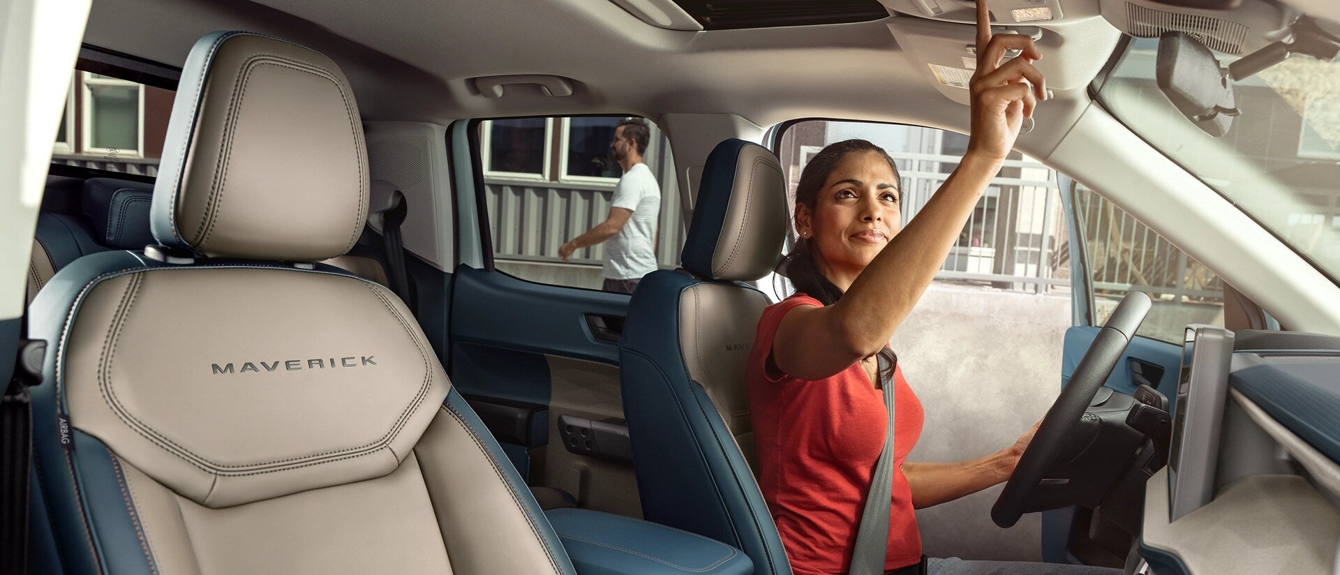 a women pushing a button inside a truck