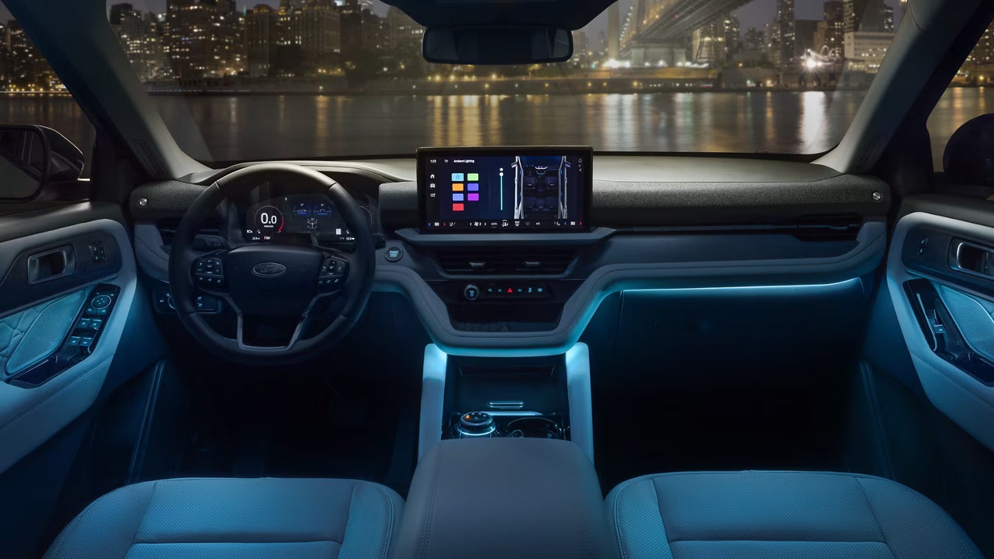 Night view of the 2025 Ford Explorer's dashboard with ambient lighting and touchscreen.